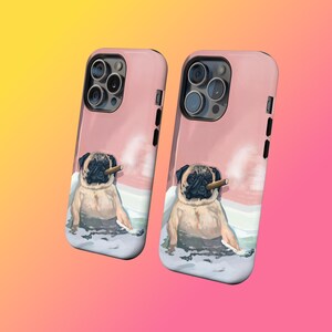 May include: Two pink phone cases with a pug dog illustration. The pug is depicted sitting in snow, holding a cigar. The cases have black side buttons and camera cutouts. The background is a watercolor-style wash of pink and white.