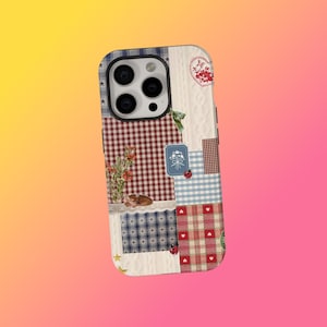 May include: A patchwork-style phone case featuring a mix of patterns including gingham, floral, and star prints. The case has a variety of colors, including red, blue, and white. A small illustration of a deer is also visible.