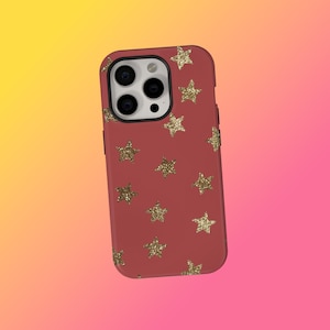 May include: A red phone case with a pattern of gold glitter stars. The case has a camera cutout and button placements. The background is a gradient of yellow, orange, and pink.