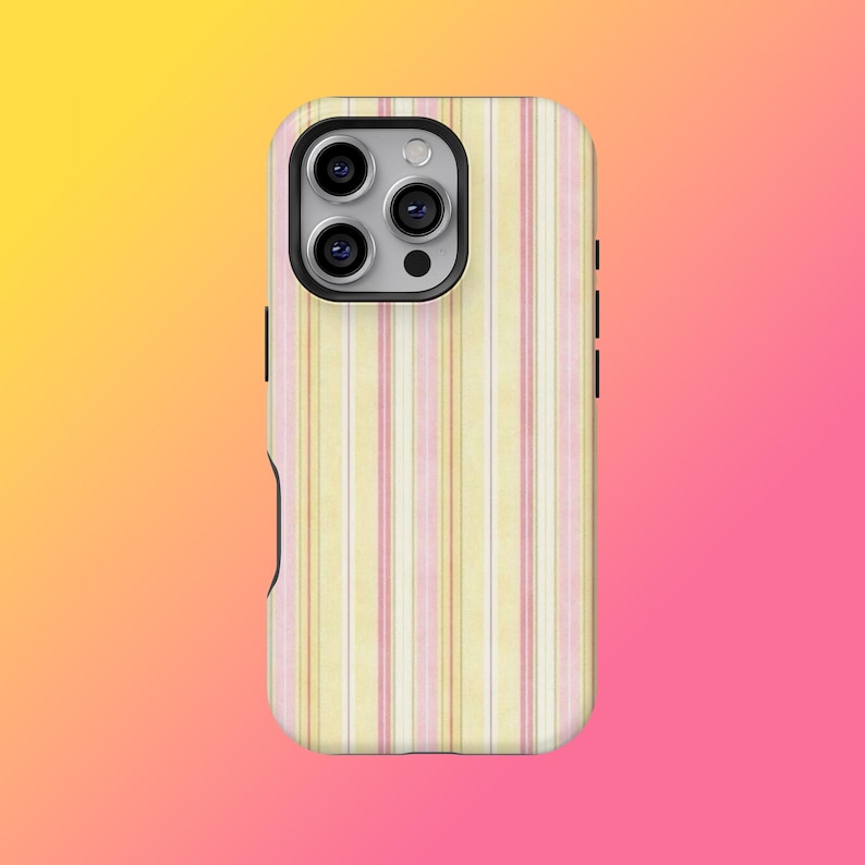 May include: A phone case with a vertical striped pattern in pastel yellow, pink, and white. The case has a black camera module and black side buttons. The background is a gradient of yellow, orange, and pink.