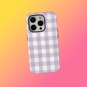 May include: A smartphone case featuring a lilac and white gingham design. The case has a black edge and covers the back and sides of the phone. The phone's camera lenses are visible.