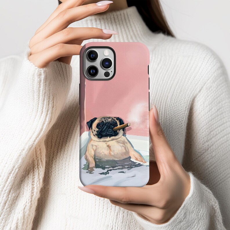 May include: A pink phone case featuring a pug dog relaxing in a bathtub, smoking a cigar. The pug is tan and black, with a relaxed expression. The background is a soft pink, creating a whimsical and humorous design.