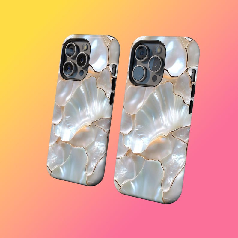 May include: Two mobile phone cases with a pearlescent, shell-like design. The cases have a white and gold colour scheme, with a glossy finish. The camera lenses are visible on the top left of each case. The background is a gradient of yellow, pink, and orange.