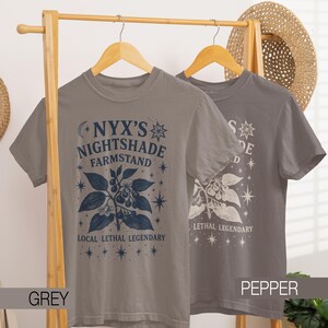 May include: Two grey t-shirts with the text "NYX'S NIGHTSHADE FARMSTAND" and "LETHAL LEGENDARY" in blue and white. The shirts feature a botanical design with stars and a plant illustration. The shirt on the right is labeled "PEPPER".