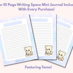 May include: Three lined journal pages with a light blue watercolor wash border and a cartoon bear illustration. The text at the top reads "Free 10 Page Writing Space Mini Journal Included With Every Purchase!" and "Featuring Tomo!" at the bottom.