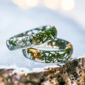 Clear resin moss ring with preserved green moss and optional metallic flakes, smooth stacking band for everyday wear.