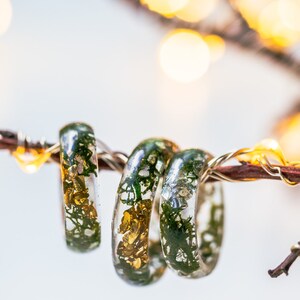 Botanical resin ring with green moss suspended in crystal-clear resin, available with gold, silver, or no flakes.