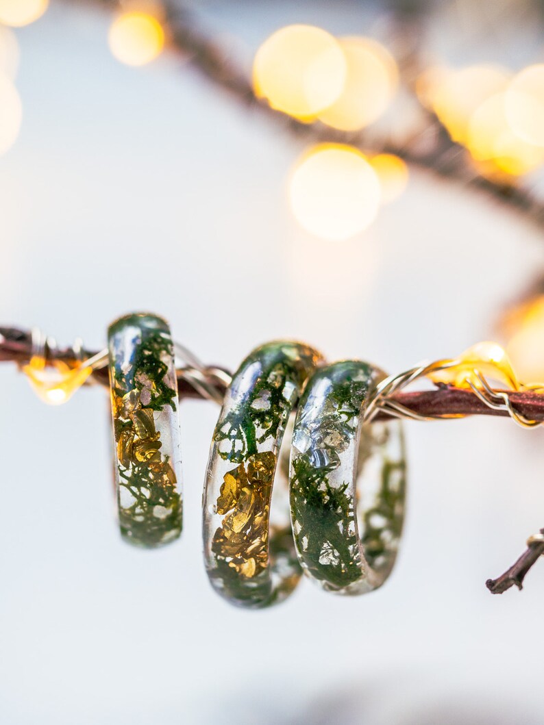 Botanical resin ring with green moss suspended in crystal-clear resin, available with gold, silver, or no flakes.