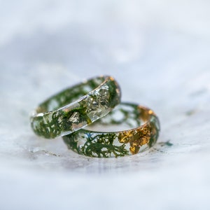 Forest inspired resin band showing real moss and shimmering flakes inside, comfortable polished ring in many sizes.