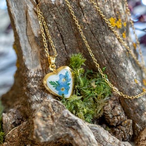 Heart locket necklace with real pressed forget me not flowers sealed in clear resin