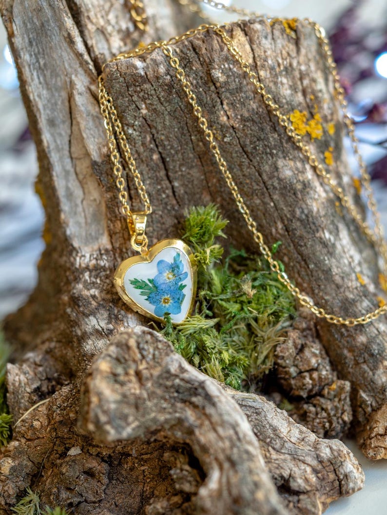 Heart locket necklace with real pressed forget me not flowers sealed in clear resin