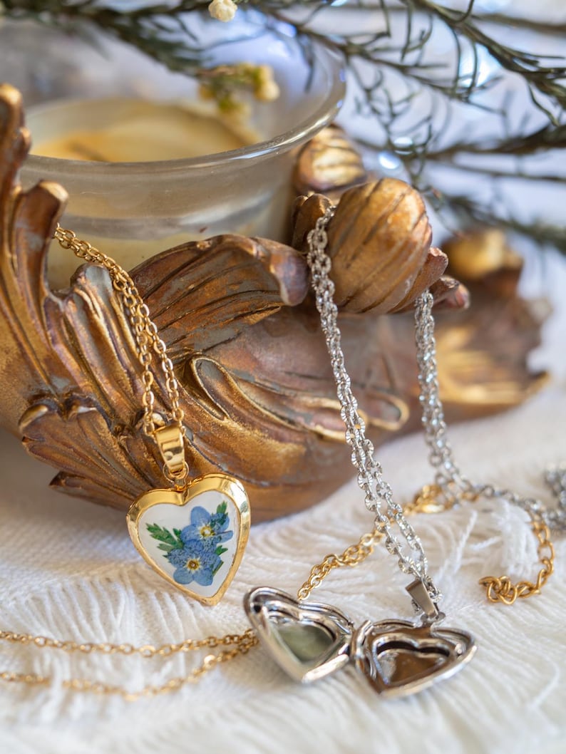Gold tone stainless steel heart locket holding blue forget me not blooms on 50cm chain