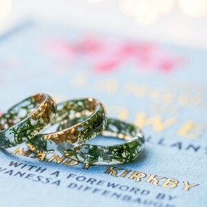 Forest inspired resin band showing real moss and shimmering flakes inside, comfortable polished ring in many sizes.