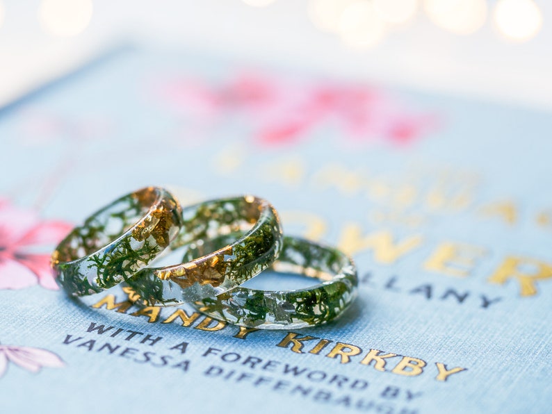 Forest inspired resin band showing real moss and shimmering flakes inside, comfortable polished ring in many sizes.