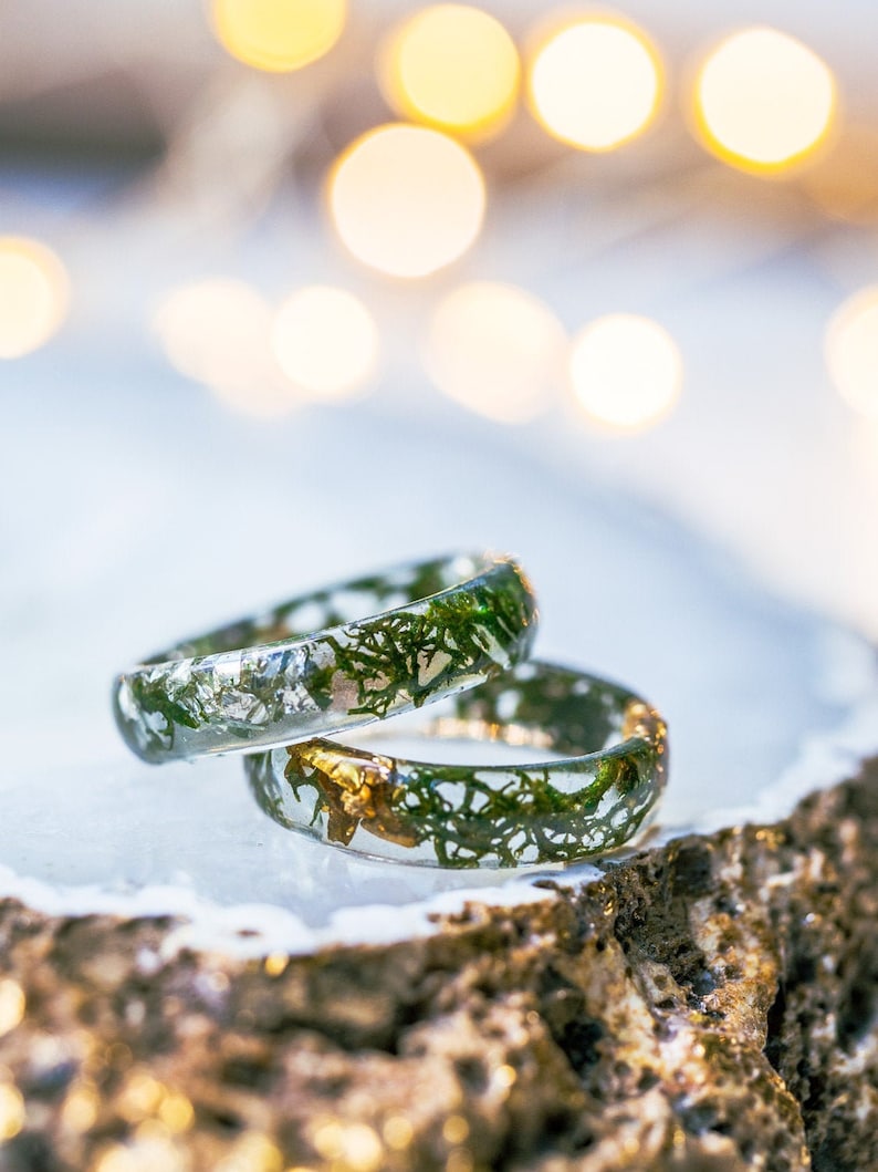 Clear resin moss ring with preserved green moss and optional metallic flakes, smooth stacking band for everyday wear.