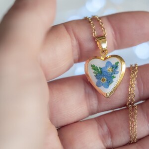 Gold tone stainless steel heart locket holding blue forget me not blooms on 50cm chain