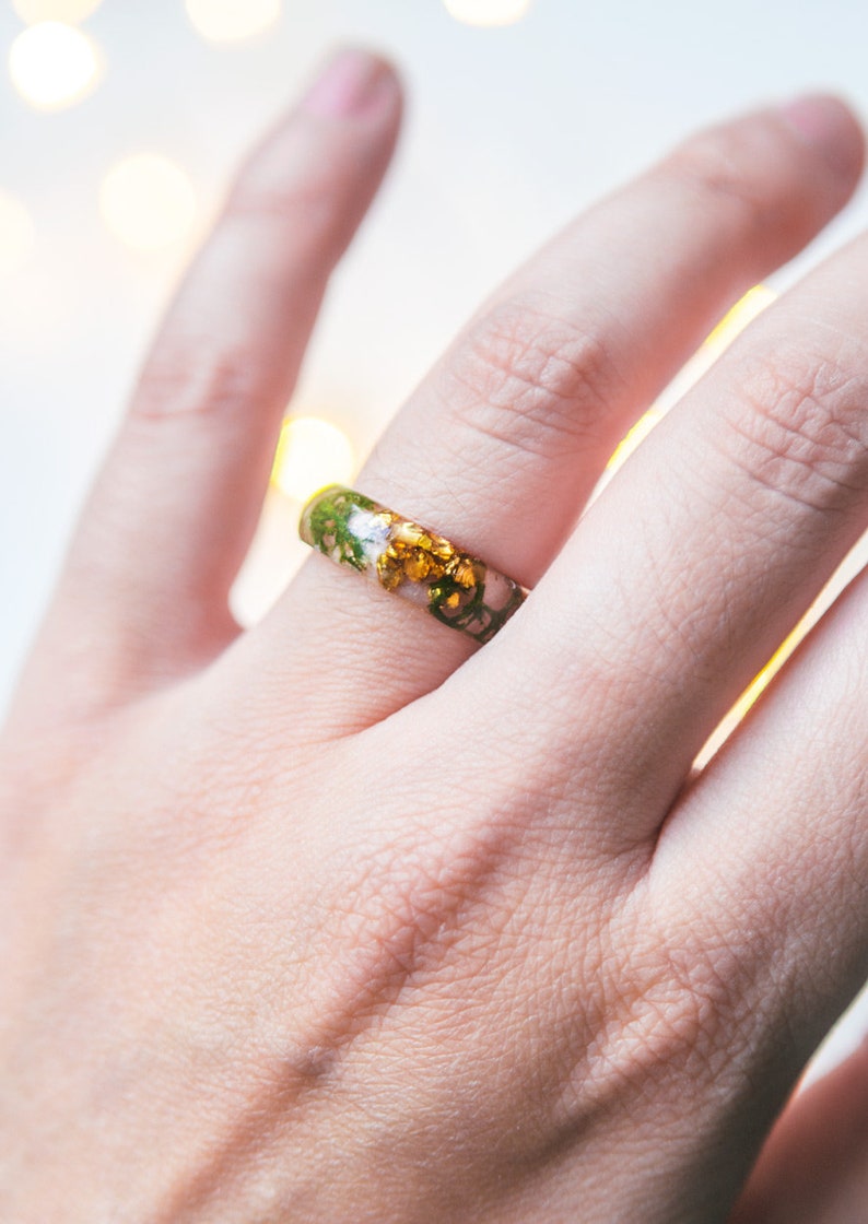 Botanical resin ring with green moss suspended in crystal-clear resin, available with gold, silver, or no flakes.