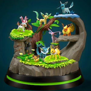 May include: A detailed figurine featuring multiple Pokémon characters in a naturalistic setting. The sculpture includes various creatures in different colors, set on a rocky base with green accents and a black base with a green light.
