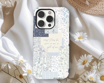 May include: A phone case with a patchwork design in shades of blue and white. The case features floral and geometric patterns, with the text "may Jesus be seen in me in spite of me".