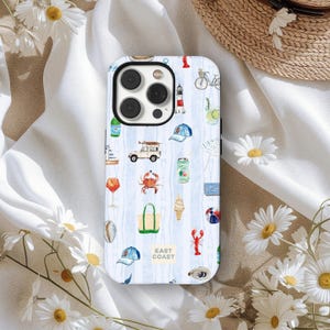 May include: A phone case with a coastal theme, featuring illustrations of a sailboat, crab, ice cream cone, and other beach-related icons. The case has a light blue and white striped background and the words "East Coast" in a yellow rectangle.