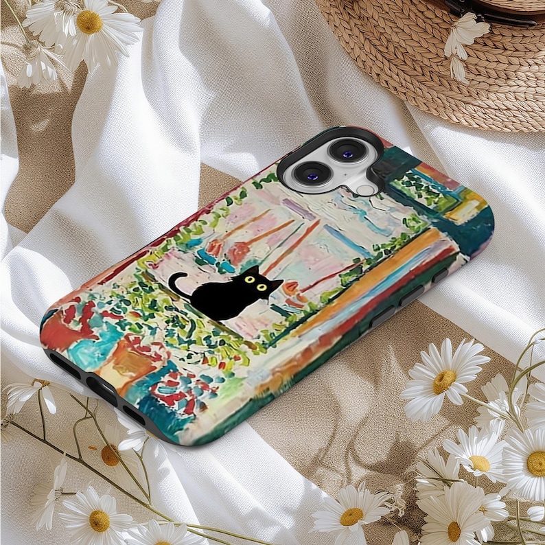 May include: A colorful phone case featuring a black cat silhouette with yellow eyes, set against a vibrant, impressionistic garden scene. The case has a black border and a camera cutout.