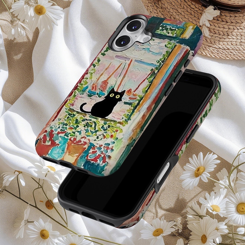 May include: A black smartphone case featuring a colorful, impressionistic painting of a cat looking out a window. The artwork includes a black cat with yellow eyes, boats, and a vibrant array of colors. The case is shown with a black smartphone.