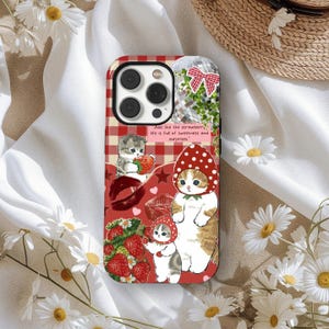 May include: A red and white plaid phone case featuring illustrations of cats, strawberries, and the text "Just like the strawberry, life is full of sweetness and surprises." The case has a whimsical, cartoonish style.