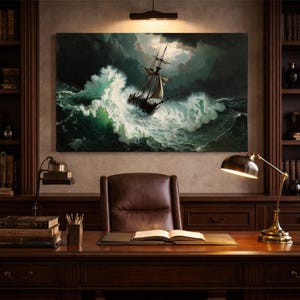 May include: An oil painting of a ship at sea during a storm hangs above a wooden desk in a home office. The painting depicts a ship tossed in turbulent green and white waves under a dark, cloudy sky. The office features a leather chair, bookshelves, and a desk lamp.