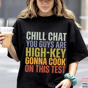 May include: Black t-shirt with the text "CHILL CHAT YOU GUYS ARE HIGH-KEY GONNA COOK ON THIS TEST" in various colors. The shirt is a crew neck style.