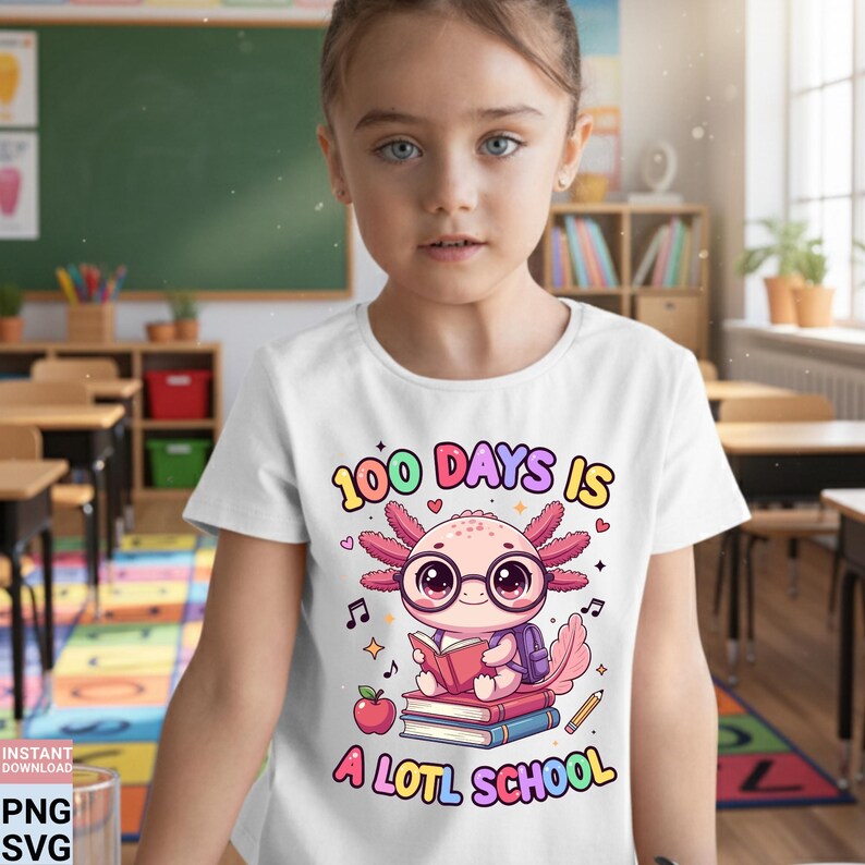 May include: A white t-shirt with a colorful graphic featuring an axolotl wearing glasses and a backpack, reading a book. The text reads "100 Days Is A LOTL School". The design includes musical notes, an apple, and a pencil.