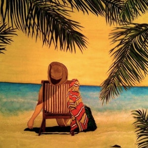 May include: A person wearing a hat sits in a striped beach chair on a sandy beach. The person is facing away from the viewer and looking out at the ocean. The ocean is blue and the sky is yellow. Palm trees are in the background.