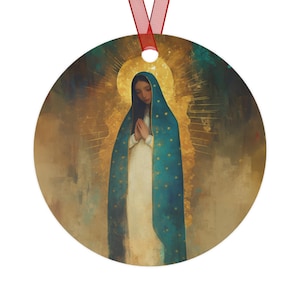 May include: Round Christmas ornament featuring a religious painting of a woman in a blue cloak with gold stars, hands clasped in prayer. The background has a golden halo and a red ribbon for hanging.