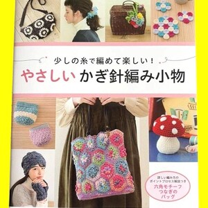 以下が含まれることがあります： 様々なかぎ針編みのプロジェクトを特集した本の表紙。バッグ、帽子、コースターなど。表紙には日本語のテキストがあり、カラフルな手作りのアイテムを紹介しています。本のタイトルは日本語です。