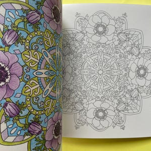 May include: A coloring book page featuring a circular floral mandala design. The left side shows a partially colored version with purple flowers, light blue backgrounds, and green leaves, while the right side displays the original black and white line art.