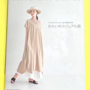 May include: A book cover titled "Casual Chic Clothes" features a woman wearing a beige dress and a straw hat. The text on the cover includes Japanese characters and the phrase "Heart Warming Life Series."