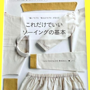 Könnte beinhalten: Ein Nähbuch mit japanischem Text und Stoffmustern. Auf dem Cover steht der Titel "Kore dake de ii So-ingu no Kihon" und der Name des Autors. Das Buch gehört zur Heart Warming Life Series.