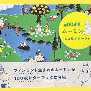 May include: A Moomin-themed stationery set featuring a colorful illustration of Moomin characters in a whimsical landscape. The set includes a yellow circle with Japanese text and a white banner with Japanese text. The background is a vibrant green and blue.