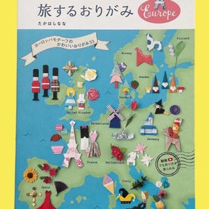 May include: A book cover showing a map of Europe decorated with origami figures. The title is in Japanese, with the word "Europe" in English. Origami models include a windmill, Eiffel Tower, and a red dress. The text reads "nanahoshi's Traveling Origami".