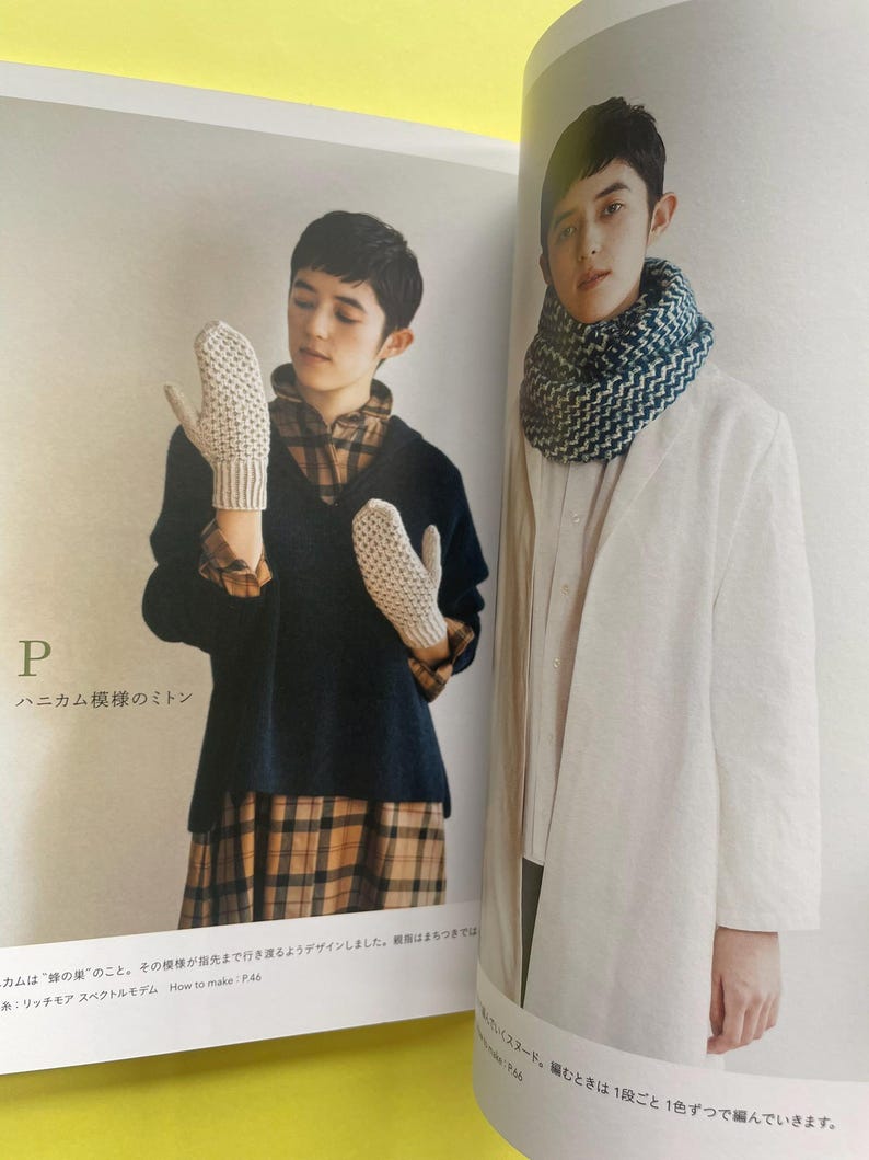 May include: A page from a craft book showing two knitted items. On the left, a pair of off-white honeycomb-patterned mittens. On the right, a thick, textured infinity scarf featuring a blue and white chevron-style knit pattern.