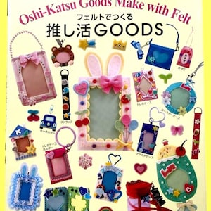 May include: A colorful craft book cover featuring various felt goods. The cover displays a variety of handmade items, including photo frames, keychains, and accessories, all crafted from felt. The text "Oshi-Katsu Goods Make with Felt" is visible.