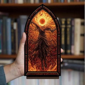 May include: A wooden, arched panel featuring a fiery illustration. The artwork depicts a central figure with a sun-like head and flowing, root-like limbs, set against a backdrop of flames. The panel is held in a hand, with a bookshelf in the background.