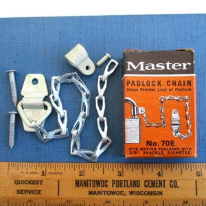 May include: A silver padlock chain with a white plastic hook and two screws. The chain is packaged in a red and orange box with the text "Master Padlock Chain" and "No. 70E" printed on it. The box also states that the chain fits Master padlocks with a 3/8 inch shackle diameter.