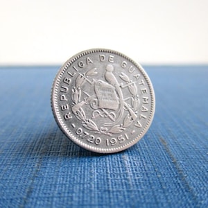 May include: Silver coin from Guatemala with the words "Republica de Guatemala" and "0.720 1951" around the edge. The coin features a bird with a crest and a shield with the words "LIBERTAD 15 DE SEPTIEMBRE DE 1821" on it.