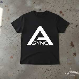 May include: A black short-sleeved t-shirt featuring a large white graphic on the chest. The graphic consists of a stylized letter A with the text ASYNC printed horizontally across the lower portion of the letter. The shirt has a crew neckline.