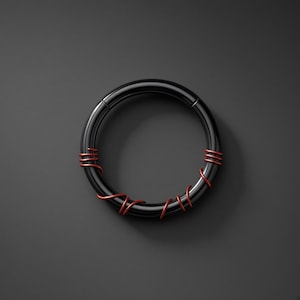May include: A circular black metal hoop ring featuring a smooth, polished finish. The ring is accented with thin, metallic red wire wrapped around the circumference at three distinct intervals, creating a contrasting decorative detail on the band.
