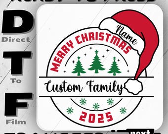 May include: A white DTF transfer design with the text "MERRY CHRISTMAS Custom Family 2025". The design includes a red Santa hat, green Christmas trees, and snowflakes. The words "READY TO PRESS" and "TRANSFER" are also present.