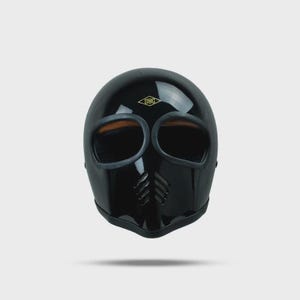 May include: Glossy black motorcycle helmet with large eye openings and a mouth vent. The helmet has a streamlined design and a gold logo at the top. The interior of the eye openings is a tan color.