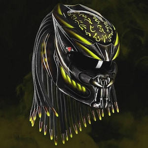 May include: A black and yellow Predator-themed motorcycle helmet. The helmet features intricate detailing, including a metallic finish, yellow accents, and dreadlocks. The design includes a visor and a mouth-like structure, creating a menacing appearance.