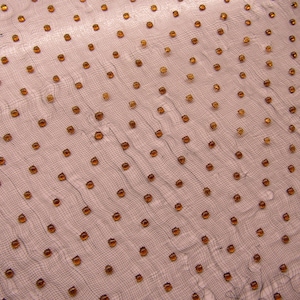 May include: A sheer, fine-mesh fabric featuring a repeating pattern of small, round, amber-colored beads or sequins evenly spaced across the surface. The translucent material has a delicate, grid-like texture with a subtle, wavy drape.