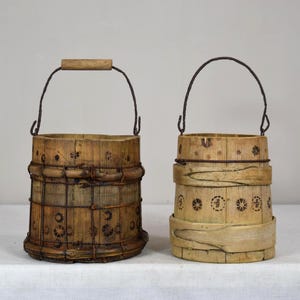 May include: A white ceramic mug with a black handle and the text "But First, Coffee" in a bold, black font. The mug is set against a neutral background, highlighting its simple design.